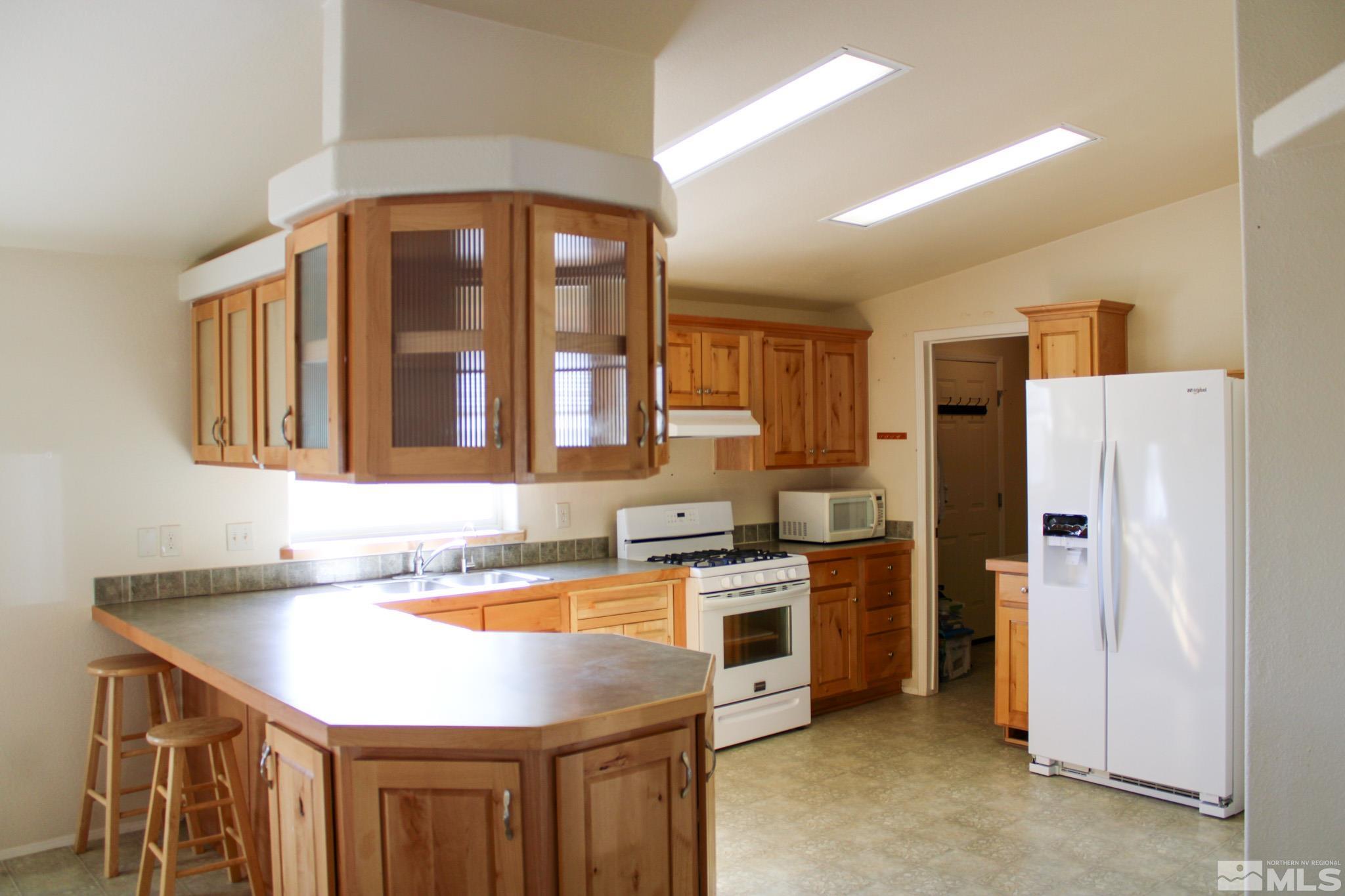 1850 Pam's Place Fallon, NV 89406 - Photo 13 of 40 a kitchen that has a lot of cabinets in it and stainless steel appliances