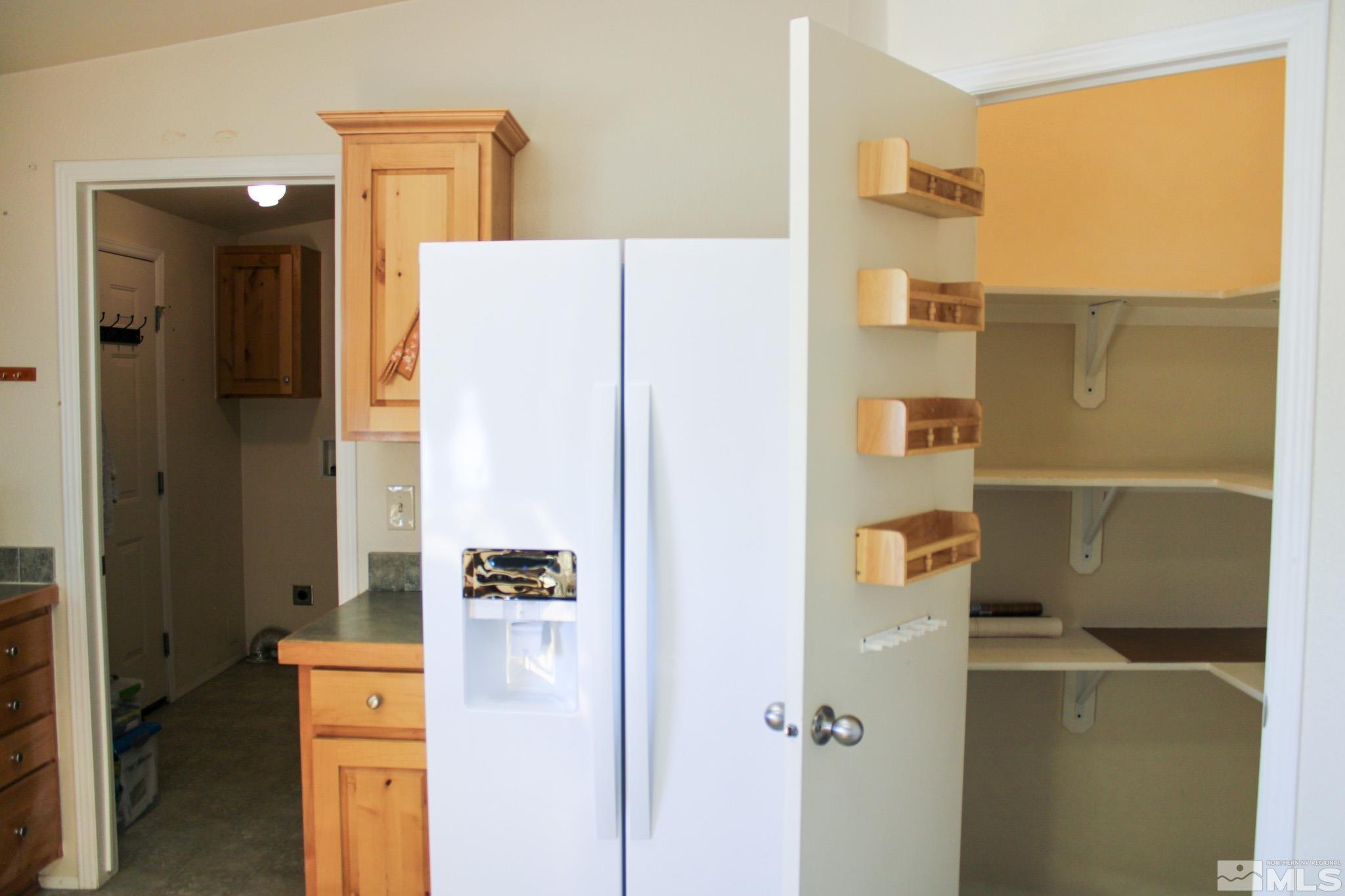 1850 Pam's Place Fallon, NV 89406 - Photo 15 of 40 a kitchen with a refrigerator and cabinets