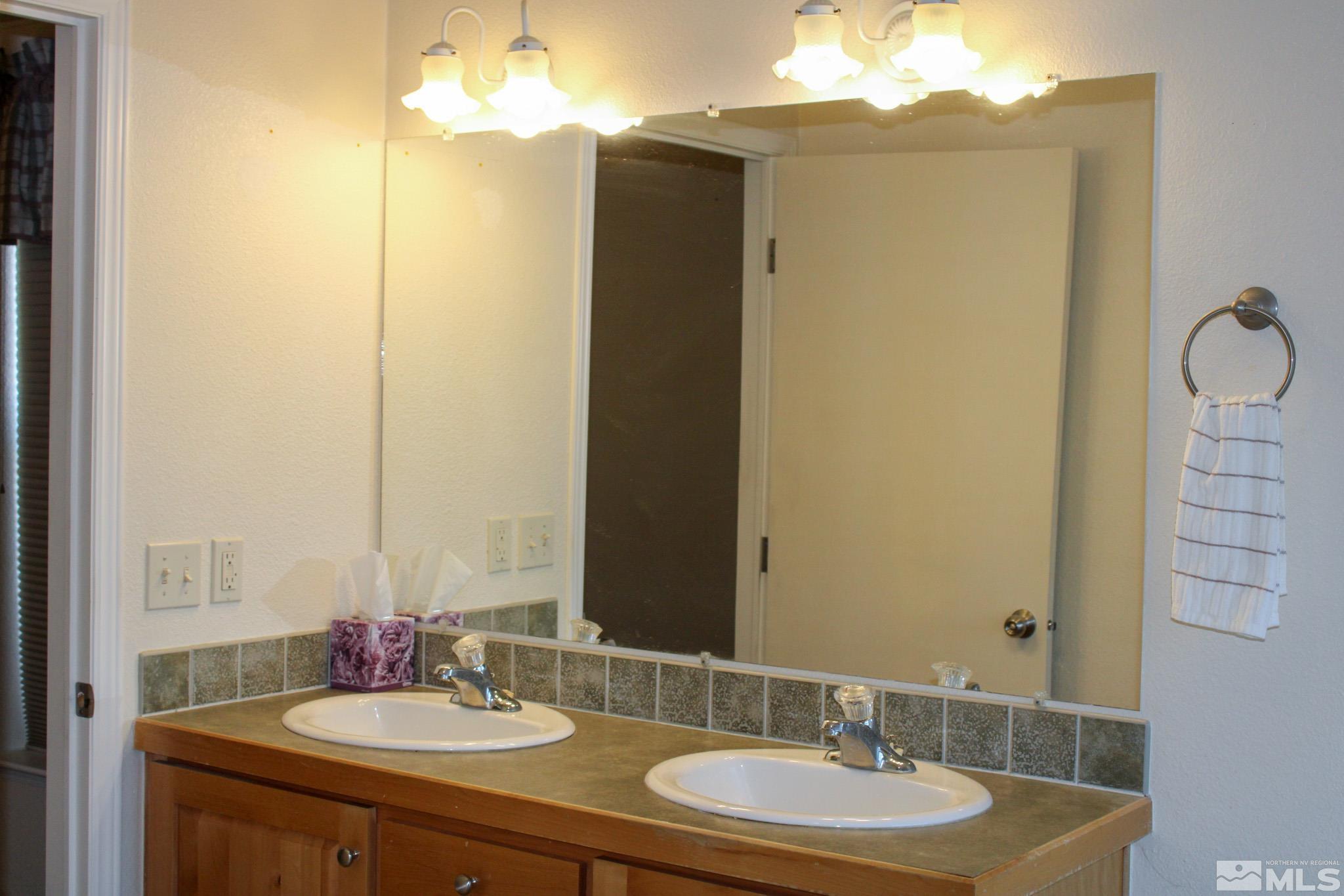 1850 Pam's Place Fallon, NV 89406 - Photo 19 of 40 a bathroom with a sink and a mirror