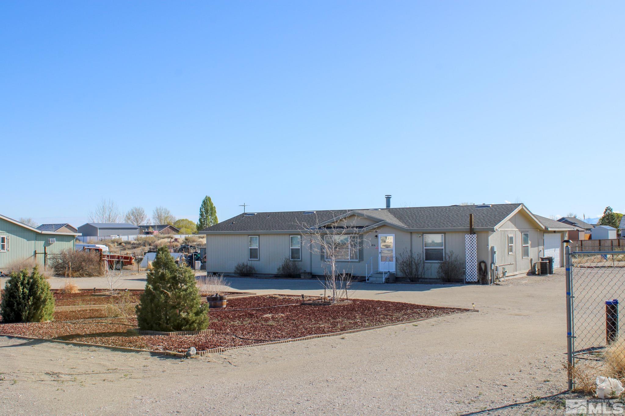 1850 Pam's Place Fallon, NV 89406 - Photo 2 of 40 a front view of a house with a yard and garage