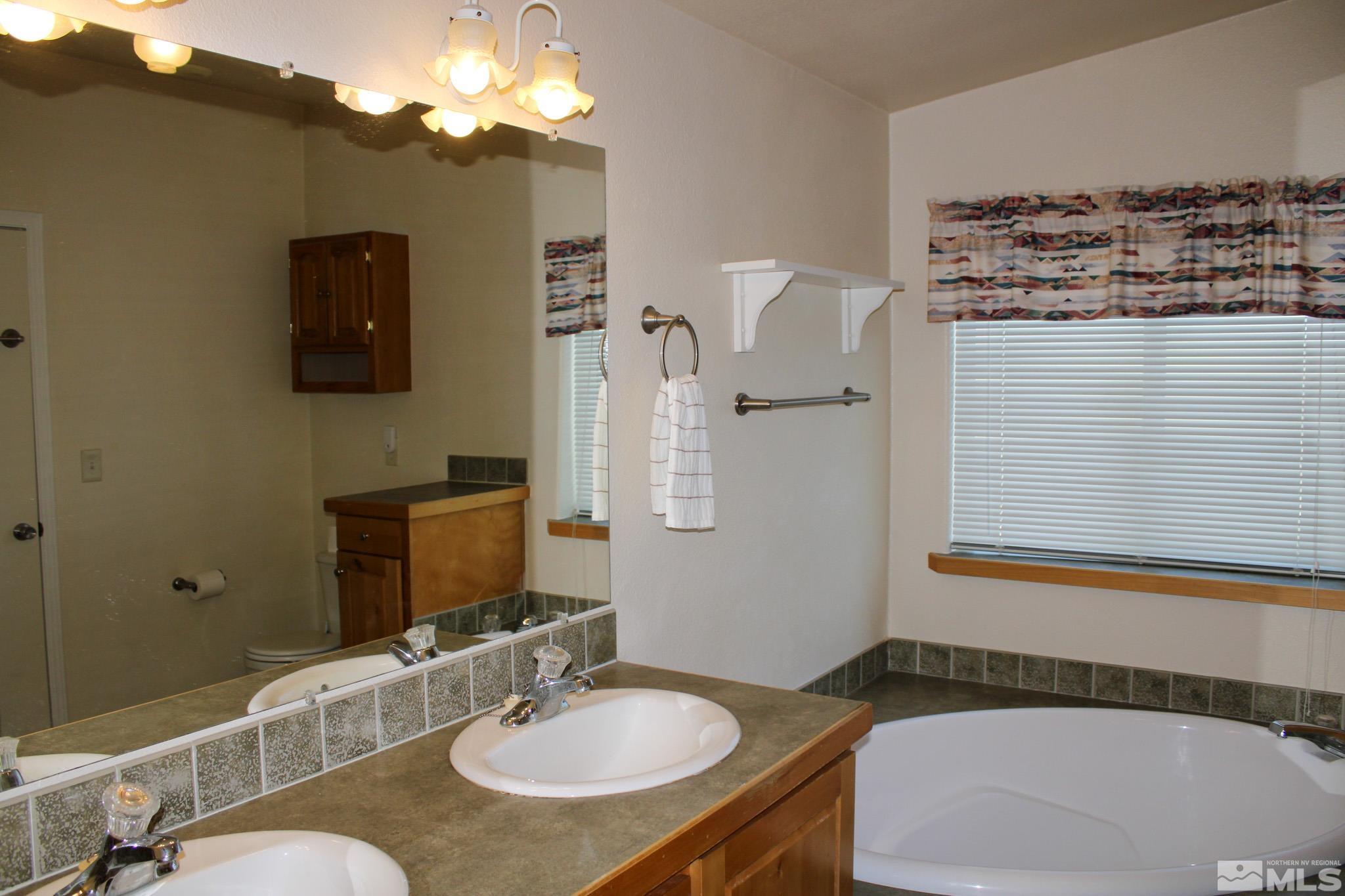 1850 Pam's Place Fallon, NV 89406 - Photo 21 of 40 a bathroom with a sink and a mirror
