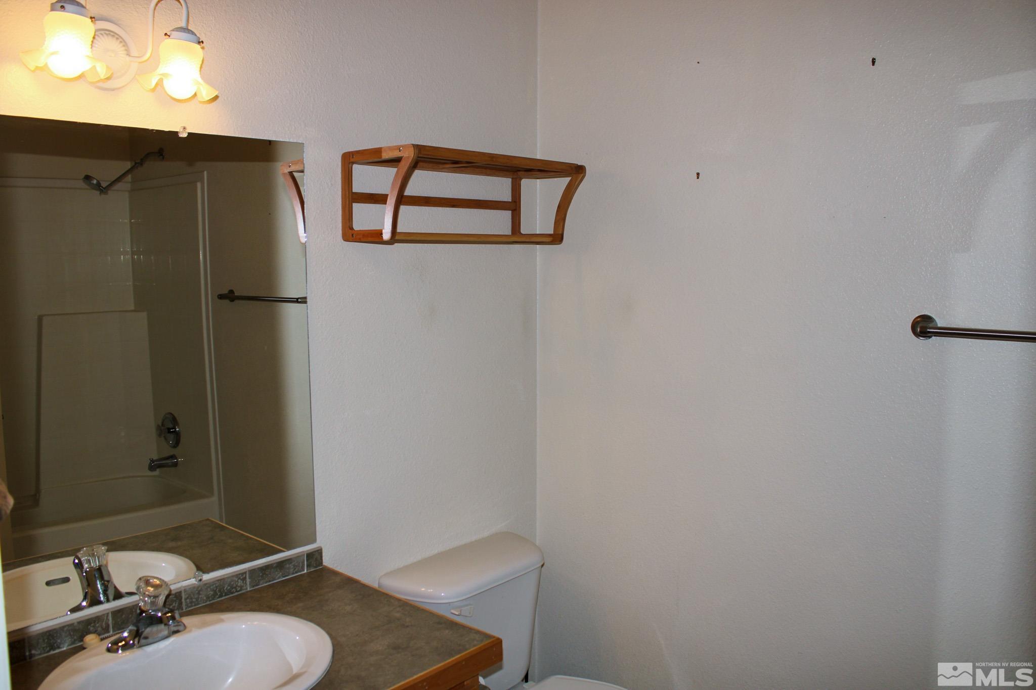 1850 Pam's Place Fallon, NV 89406 - Photo 25 of 40 a bathroom with a sink and mirror