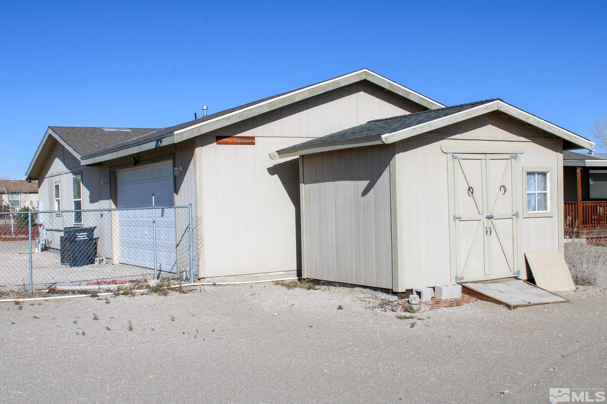 1850 Pam's Place Fallon, NV 89406 - Photo 30 of 40 a front view of a house with a wooden fence