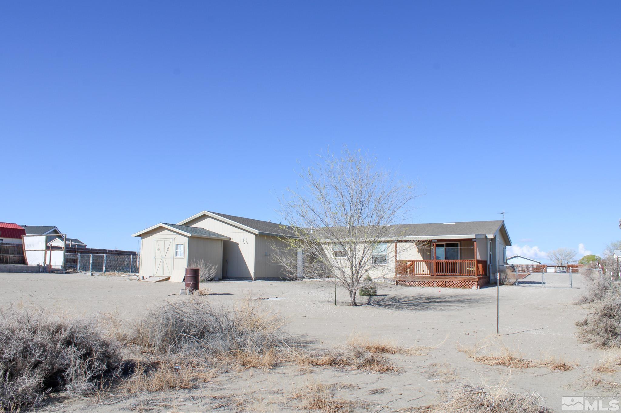 1850 Pam's Place Fallon, NV 89406 - Photo 32 of 40 a front view of a house with a yard and garage