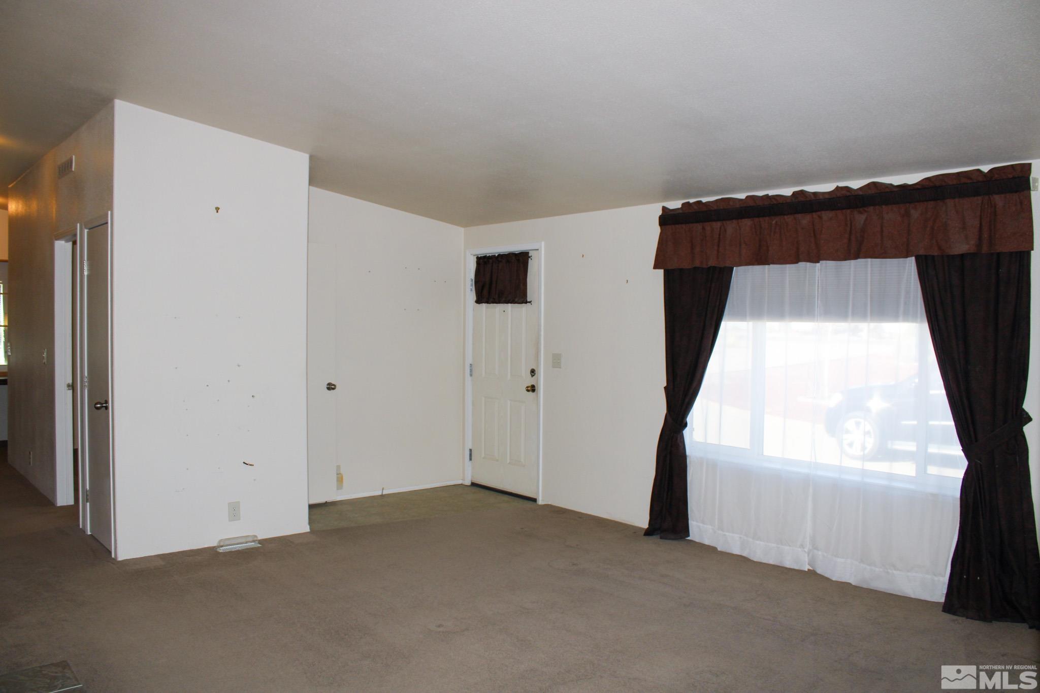 1850 Pam's Place Fallon, NV 89406 - Photo 5 of 40 a view of a room with wooden floor and windows