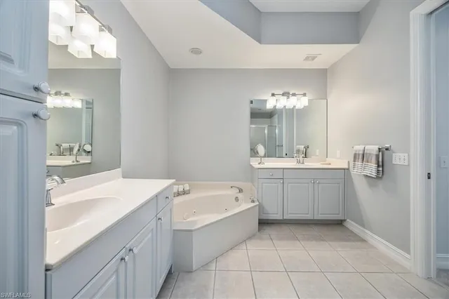 a spacious bathroom with a bathtub sink and mirror