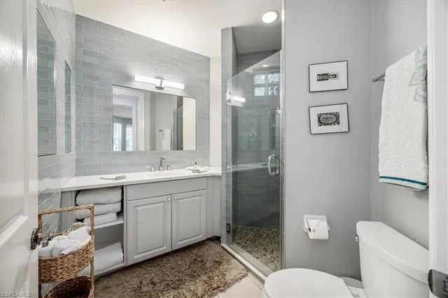 a bathroom with a toilet sink and shower