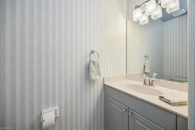 a bathroom with a sink vanity and a mirror
