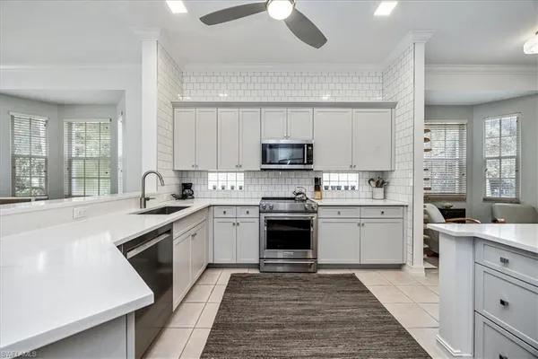 a kitchen with a sink stove and cabinets
