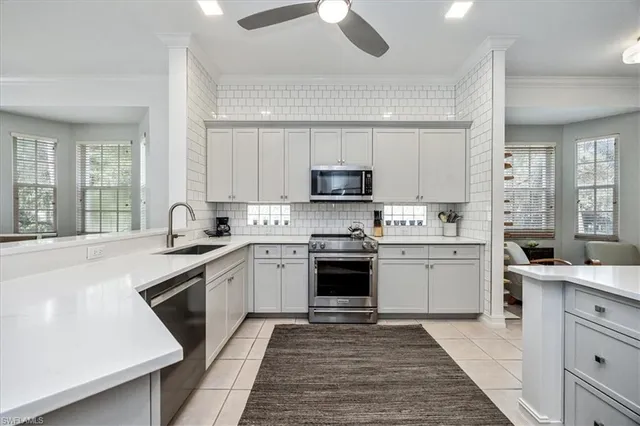 a kitchen with a sink stove and cabinets
