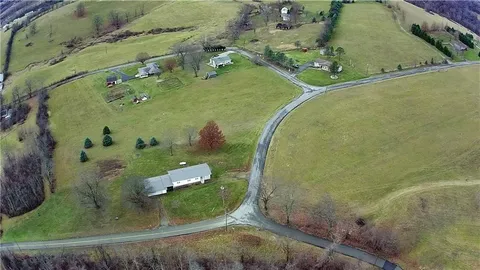 an aerial view of a residential houses with outdoor space