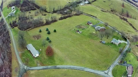 an aerial view of a residential houses with outdoor space
