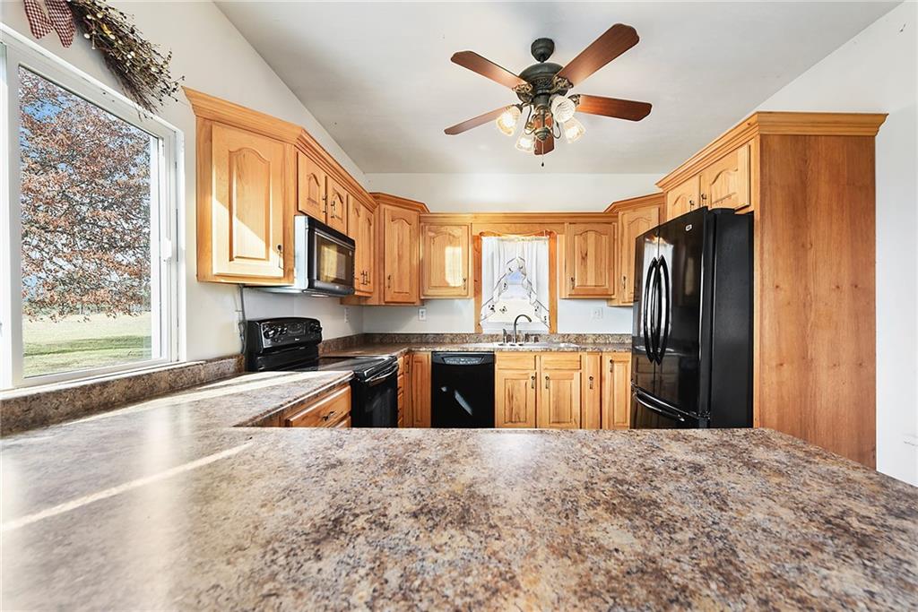 4 Malone Ridge Road Washington, PA 15301 - Photo 4 of 34 a large kitchen with granite countertop a refrigerator a stove a sink a dining table and chairs with wooden floor