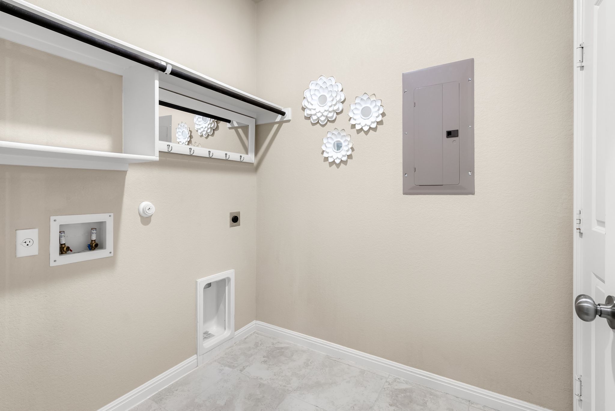 300 Prato Place Georgetown, TX 78628 - Photo 21 of 40 A dedicated utility space offers practical organization with shelving and a hanging rod for convenience.