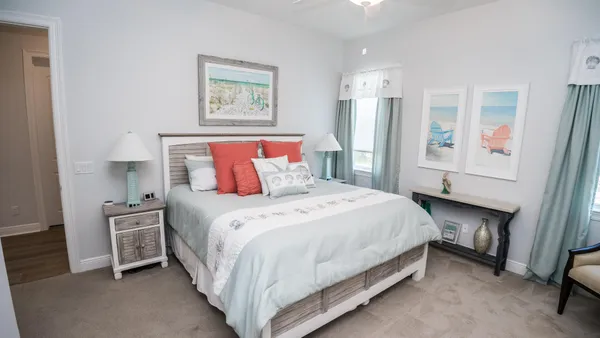 a bedroom with a bed and a potted plant
