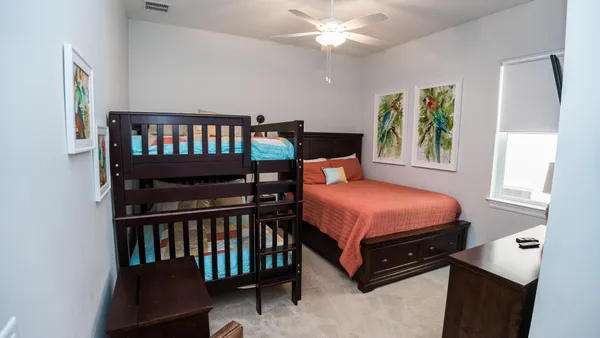 a bedroom with a bed and a tv on the dresser