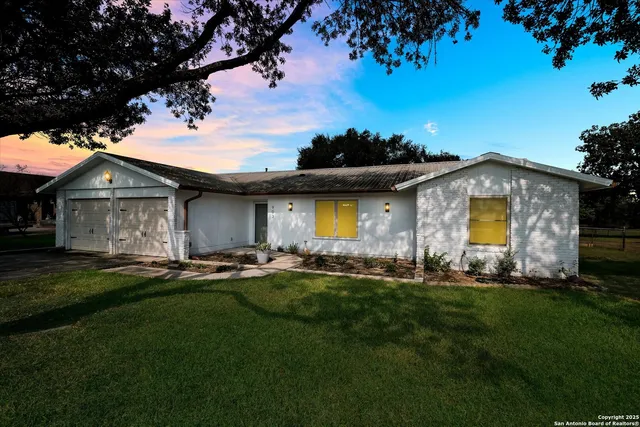 a front view of house with yard and outdoor seating