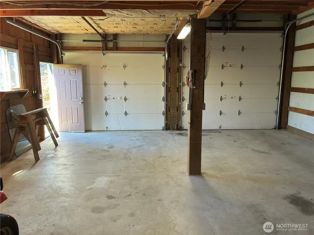a view of a hallway with wooden walls