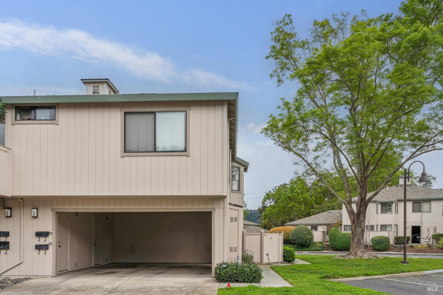 95 Dockside Circle San Rafael, CA 94903 - Photo 6 of 7 a front view of a house with a yard and garage