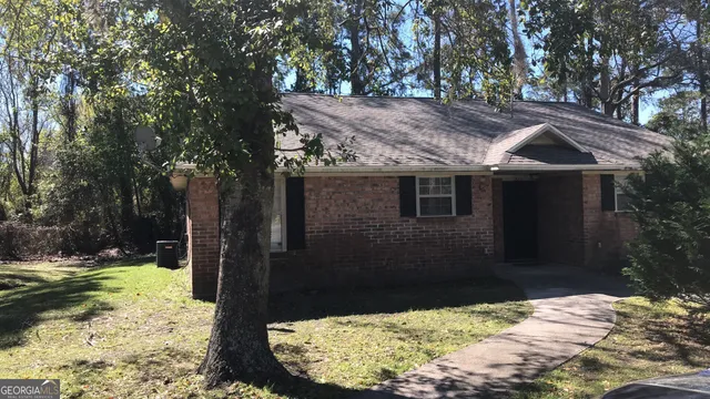 a view of a wooden house with a yard