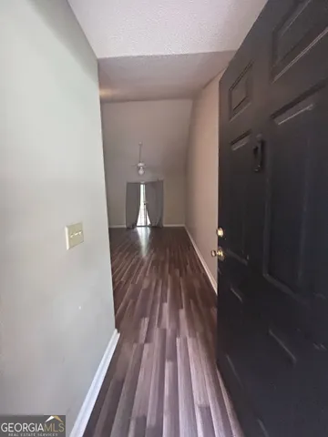 a view of a room with wooden floor