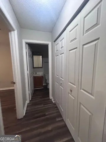 a view of a hallway view with wooden floor and staircase