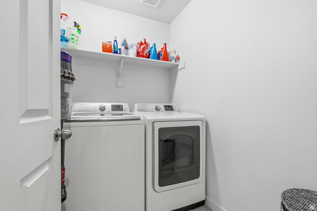 7685 Timber Country Road Eagle Mountain, UT 84005 - Photo 25 of 39 Dedicated laundry area featuring a top-load washer and front-load dryer