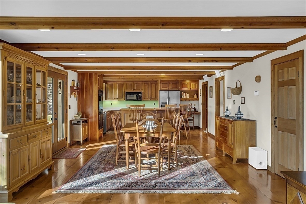 332 Still River Road Harvard, MA 01451 - Photo 12 of 42 a view of a dining room with furniture a rug and wooden floor