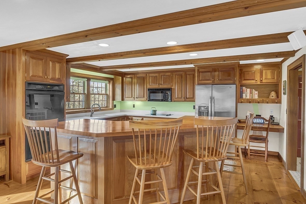 332 Still River Road Harvard, MA 01451 - Photo 19 of 42 a living room with a table and chairs