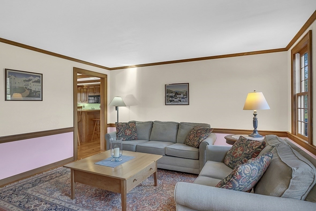 332 Still River Road Harvard, MA 01451 - Photo 24 of 42 a living room with furniture and a lamp on table with wooden floor