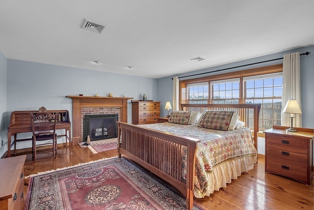 332 Still River Road Harvard, MA 01451 - Photo 26 of 42 a bedroom with a bed and a fireplace