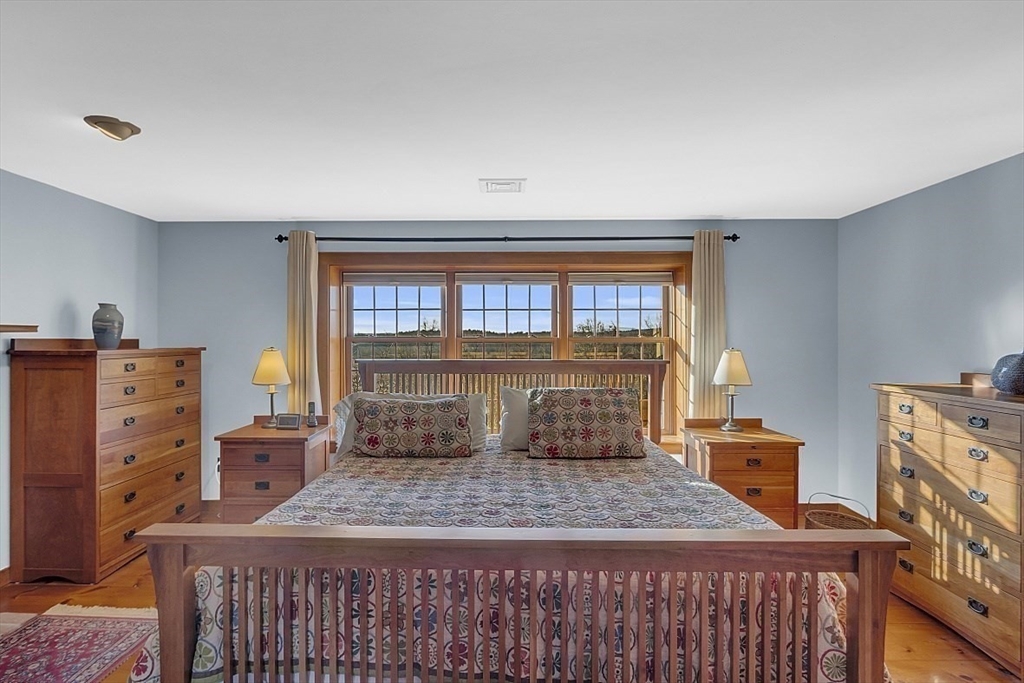 332 Still River Road Harvard, MA 01451 - Photo 27 of 42 a bedroom with a bed and wooden floor