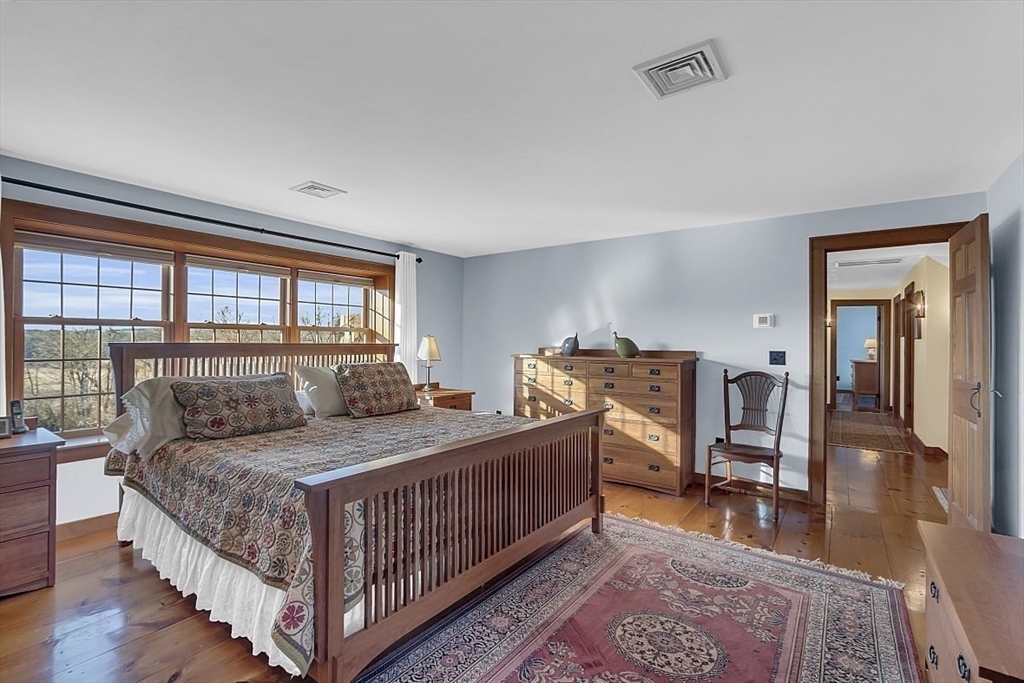 332 Still River Road Harvard, MA 01451 - Photo 28 of 42 a bedroom with a bed and wooden floor