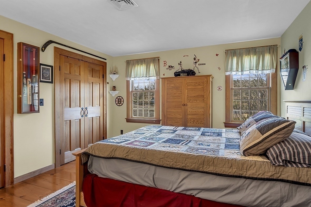 332 Still River Road Harvard, MA 01451 - Photo 33 of 42 a bedroom with a bed and wooden floor