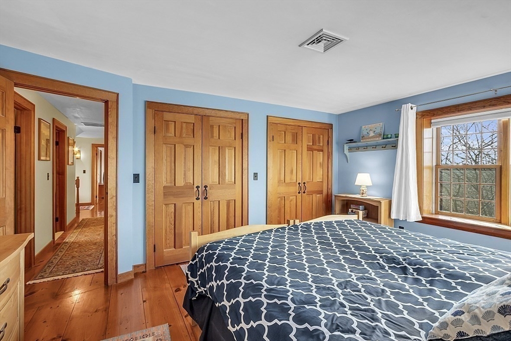 332 Still River Road Harvard, MA 01451 - Photo 36 of 42 a large bedroom with a bed and wooden floor