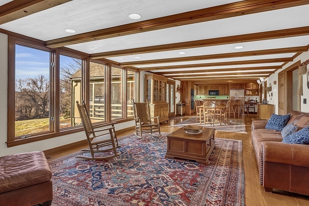 332 Still River Road Harvard, MA 01451 - Photo 10 of 42 a living room with furniture and a floor to ceiling window