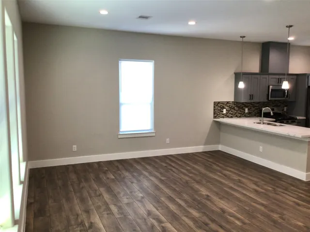a view of a kitchen with a sink and a window