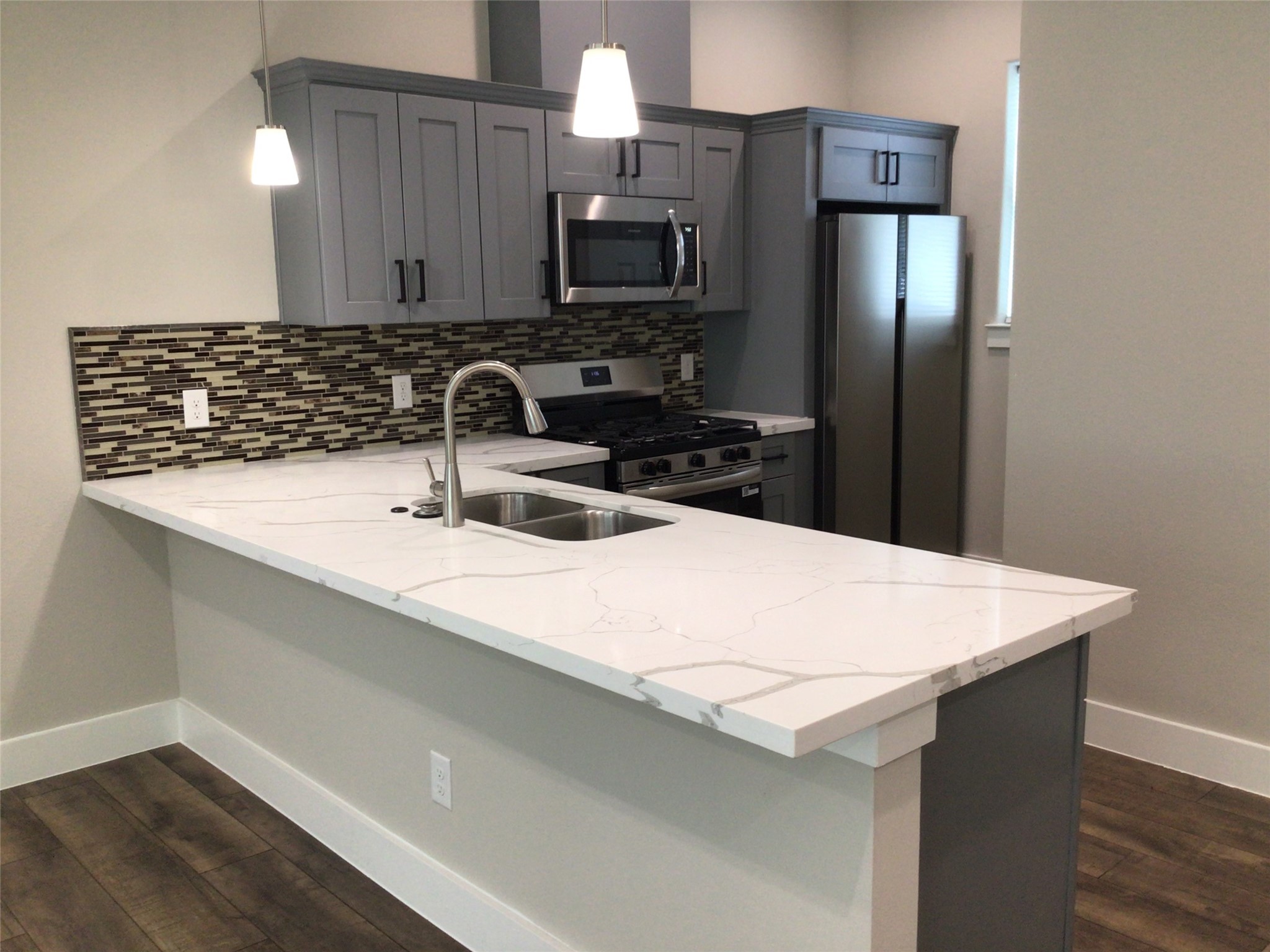 2109 Marnel Road, Unit E Houston, TX 77055 - Photo 9 of 29 a kitchen with a sink and a refrigerator