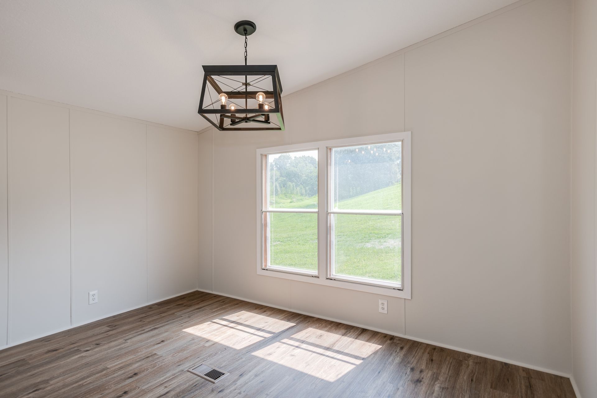 2407 Burford Road Lebanon, TN 37087 - Photo 8 of 37 an empty room with wooden floor a ceiling fan and windows