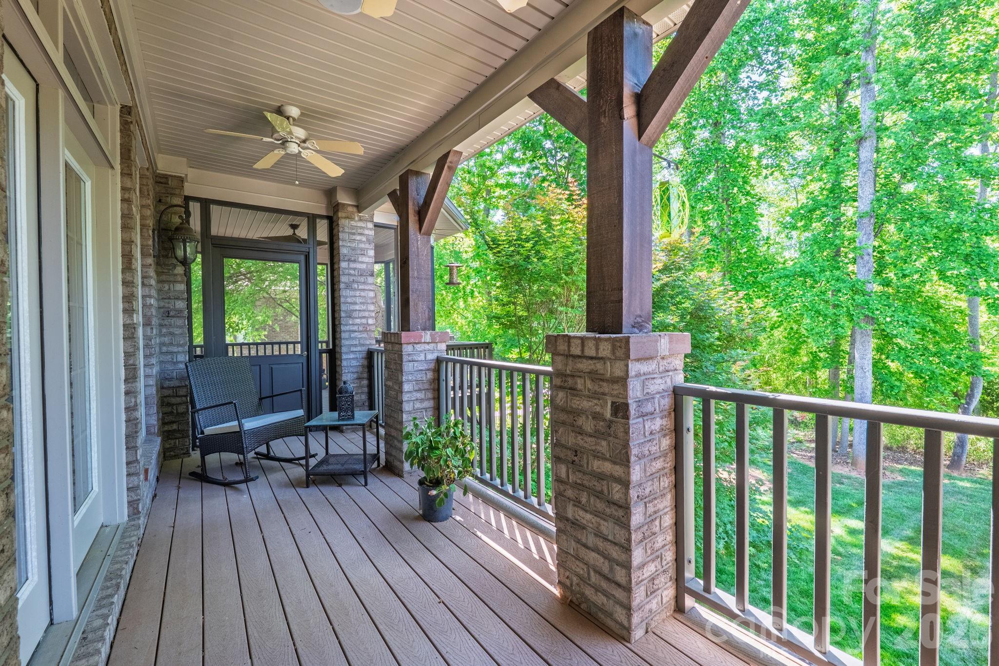 3138 Rappahannock Court, Unit 16 Matthews, NC 28104 - Photo 12 of 38 a view of a patio with lawn chairs floor to ceiling window with wooden floor