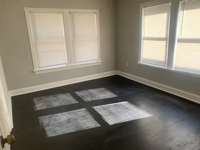 a view of an empty room with windows