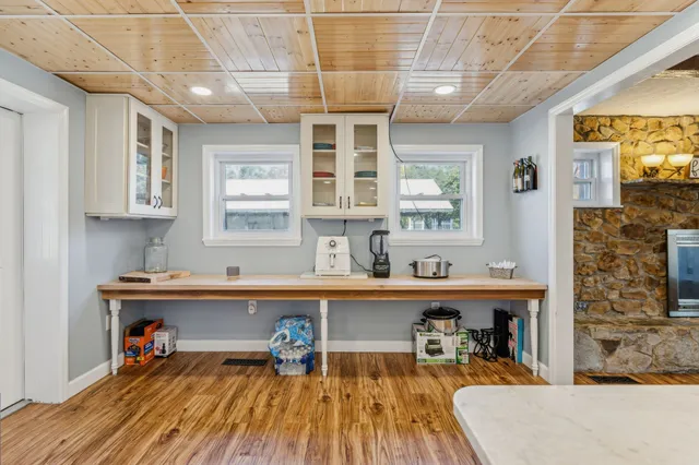 a view of a workspace with furniture and a window
