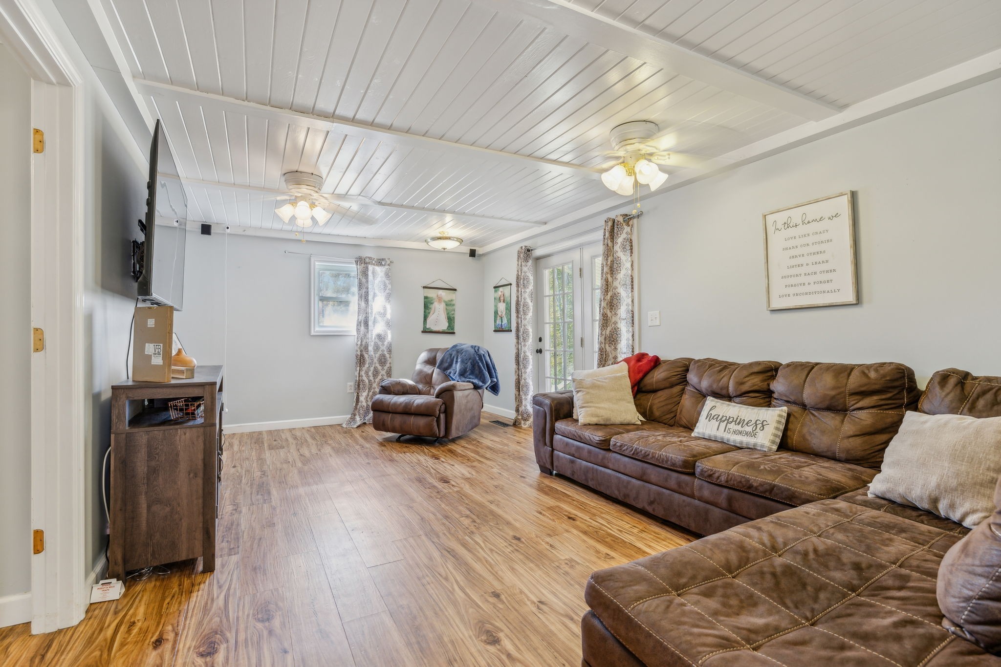 635 Cane Creek Road Hohenwald, TN 38462 - Photo 19 of 71 a living room with furniture a flat screen tv and a fireplace