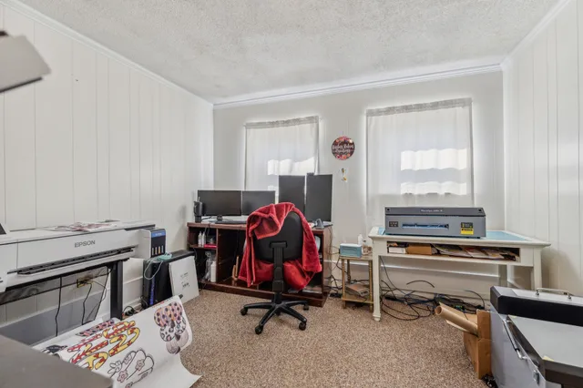 a spacious bedroom with a bed and ceiling fan