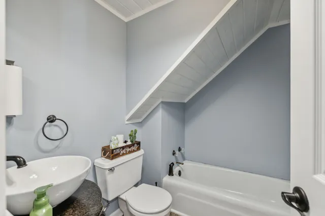 a bedroom with furniture and a flat screen tv