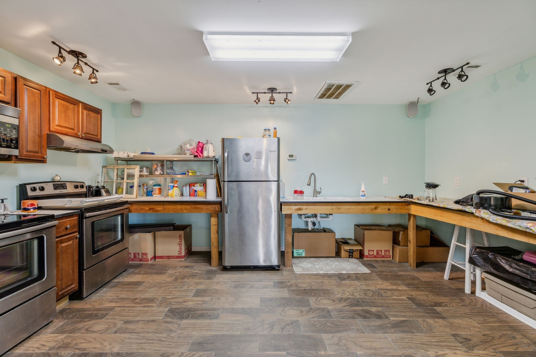 635 Cane Creek Road Hohenwald, TN 38462 - Photo 40 of 71 a utility room with stainless steel appliances granite countertop a refrigerator and a stove top oven