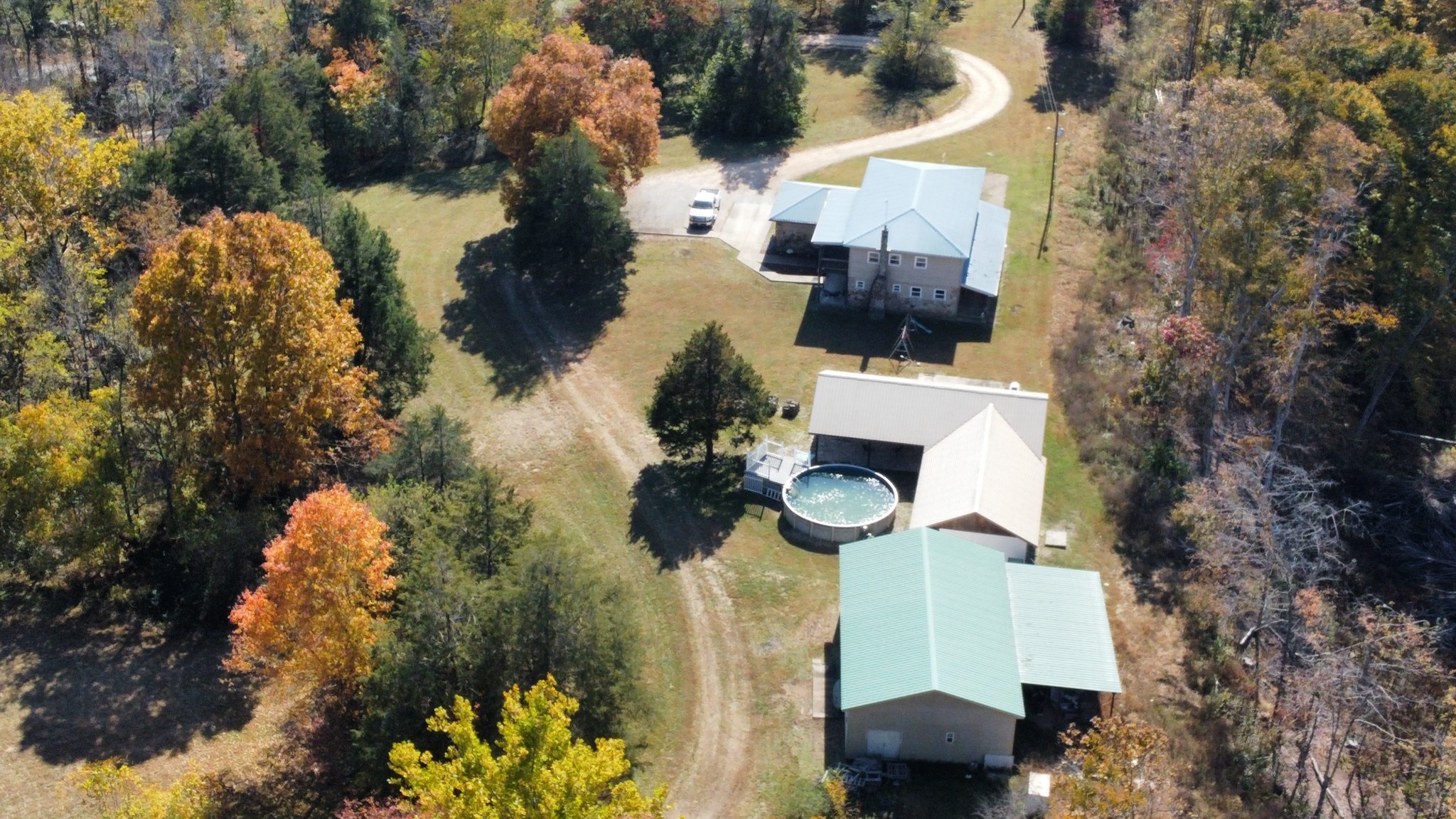 635 Cane Creek Road Hohenwald, TN 38462 - Photo 50 of 71 an aerial view of a house with a yard and lake view