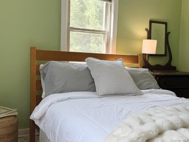 26 Woods Road Barryville, NY 12719 - Photo 11 of 34 a bedroom with a bed and a lamp