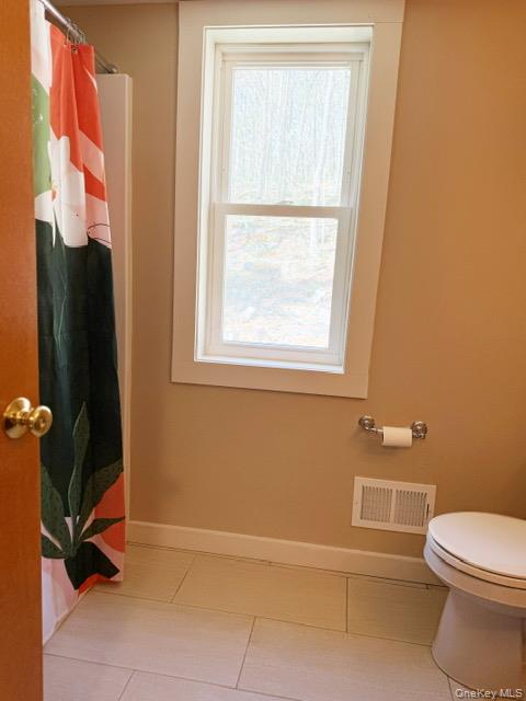 26 Woods Road Barryville, NY 12719 - Photo 17 of 34 a bathroom with a toilet and a tub
