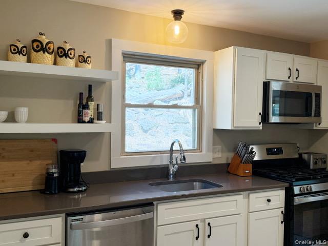 26 Woods Road Barryville, NY 12719 - Photo 8 of 34 a kitchen with a sink and cabinets